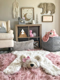 White fluffy polar bear rug made by ClaraLoo on the floor of a forest themed nursery.